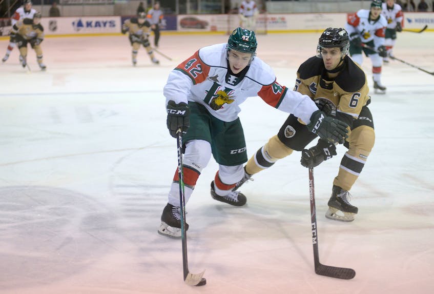 Halifax Mooseheads centre Zack Jones, left, shields the puck from Charlottetown Islanders defenceman Noah Laaouan during a QMJHL game at the Eastlink Centre in Charlottetown. - Jason Malloy