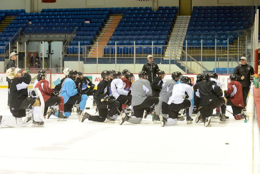 Players listen to associate coach Guy Girouard explain a drill during Thursday's Charlottetown Islanders practice.