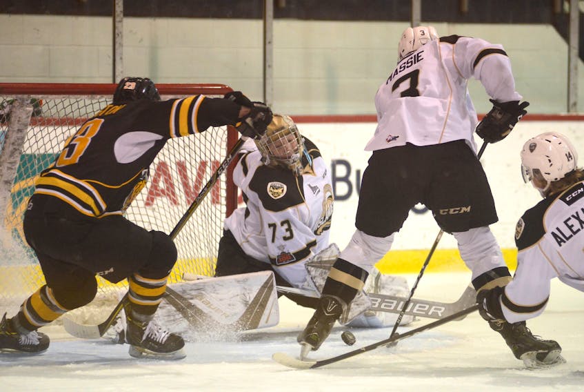 Charlottetown Islanders goalie Matthew Welsh slides across the ice to make a save with Victoriaville Tigres right-winger Jimmy Huntington crashing the net Friday at the Eastlink Centre.