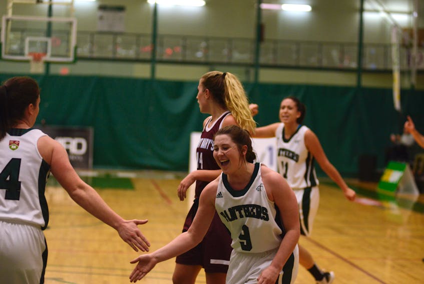 UPEI Panthers guard Reese Baxendale, right, congratulates teammate Jenna Mae Ellsworth for hitting a layup while being fouled Friday during Atlantic University Sport women's basketball action with Saint Mary's.