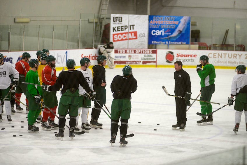 UPEI Panthers men's hockey head coach Forbes MacPherson speaks to his players during Wednesday's practice.