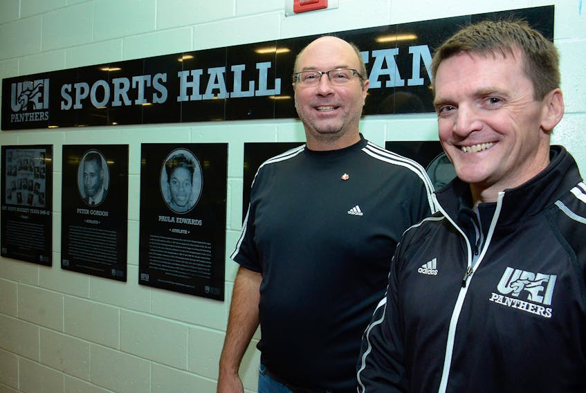 Athletics director Chris Huggan, right, and women’s soccer coach Glen Miller in the UPEI Sports Hall of Fame, which is located on the walking track in the UPEI Chi-Wan Young Sports Centre. “This is a high-traffic area and that’s why we put it here,” Huggan said. “Every game there’s people just looking, browsing, reading.”