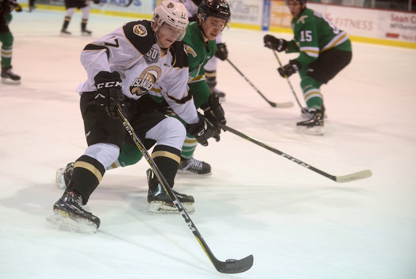 Charlottetown Islanders left-winger Liam Peyton, left, tries to drive to the net against Val-d'Or Foreurs defenceman Karl Boudrias Wednesday during Quebec Major Junior Hockey League action at the Eastlink Centre.