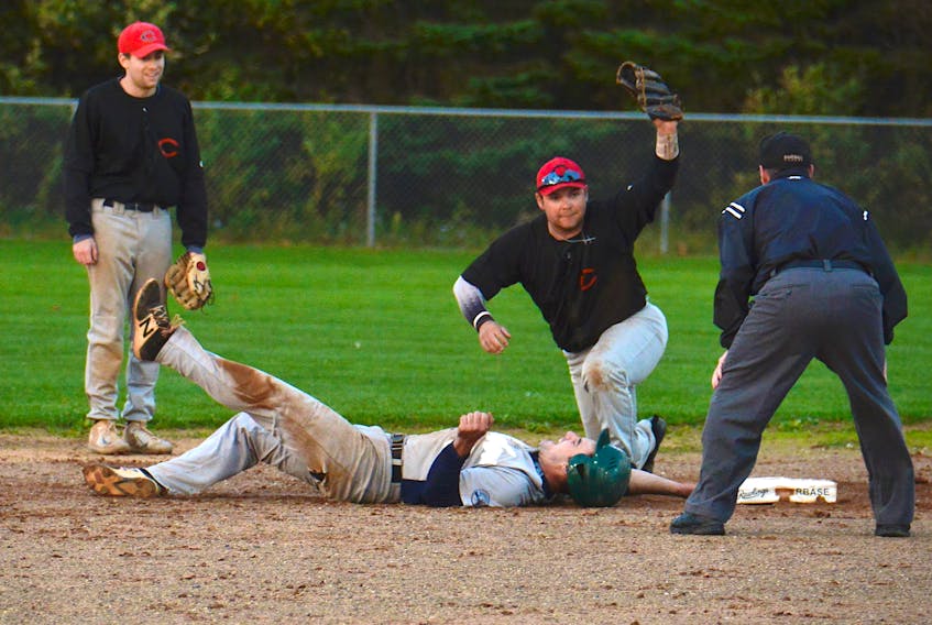 Morell Chevies shortstop Logan Gallant shows the umpire the ball after tagging out Dillon Doucette of the Peakes Bombers during Game 5 of the Kings County Baseball League semifinal Sunday in Morell.