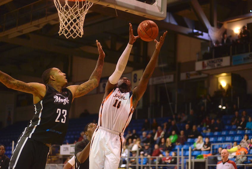 Island Storm forward Lewis Diankulu, right, goes after an offensive rebound against Moncton Magic big man Billy White Friday during National Basketball League of Canada action at the Eastlink Centre.