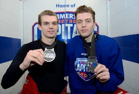 Summerside D. Alex MacDonald Ford Western Capitals teammates Zach Biggar, left, and Colby MacArthur show the silver medals they won with Team Canada East at the World Junior A Challenge Sunday in Dawson Creek, B.C.