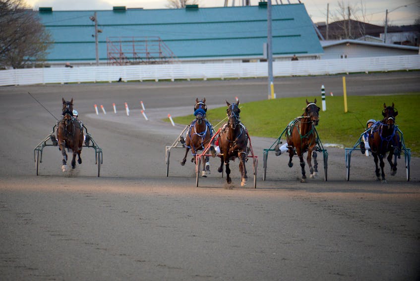 Euchred with David Dowling in the bike crosses the finish line first Saturday in the featured race at Red Shores at the Charlottetown Driving Park.