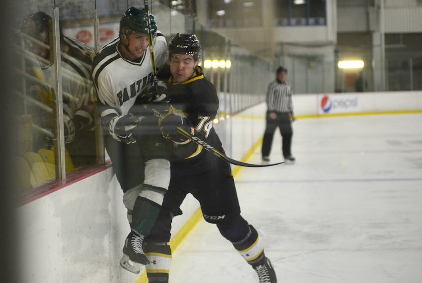 UPEI Panthers forward Kameron Kielly absorbs a hit from Dalhousie Tigers defenceman Aiden Jamieson along the boards during first period action Friday at MacLauchlan Arena.