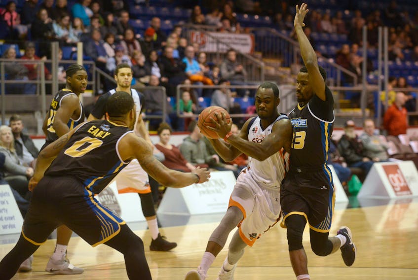 Island Storm guard Malik Story, left, drives to the bucket against Saint John Riptide’s Jeremiah Mordi Sunday during National Basketball League of Canada play at the Eastlink Centre.