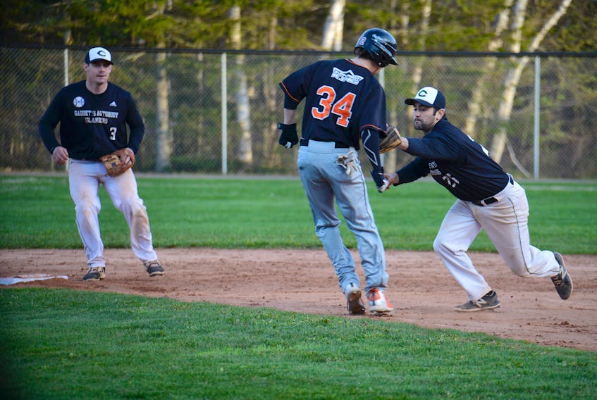 Charlottetown Gaudet's Auto Body Islanders second baseman Jesse MacIntyre, right, goes for the tag of a Moncton Fisher Cats runner Tuesday during New Brunswick Senior Baseball League game at Memorial Field.