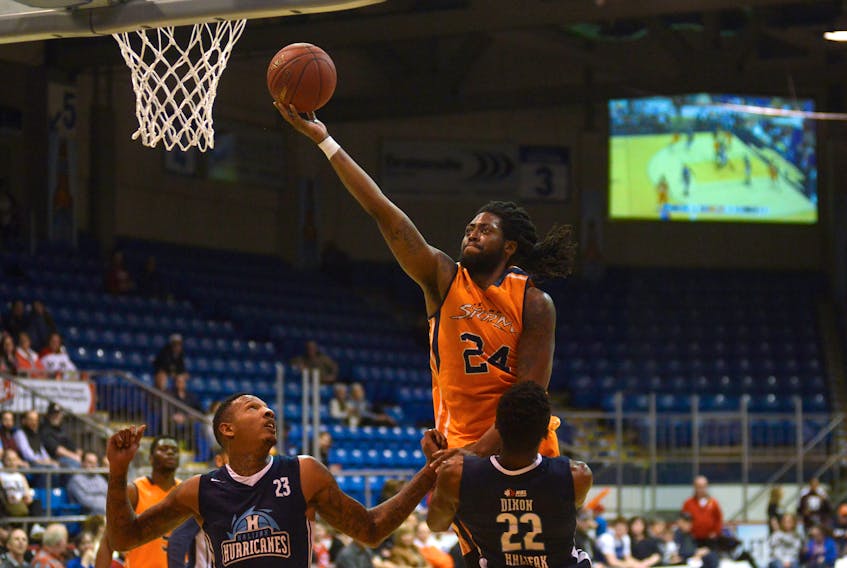 Island Storm forward Chris Anderson goes for the layup, but is called for the offensive foul as Halifax Hurricanes forward Renaldo Dixon draws the charge Thursday at the Eastlink Centre during National Basketball League of Canada playoff action.