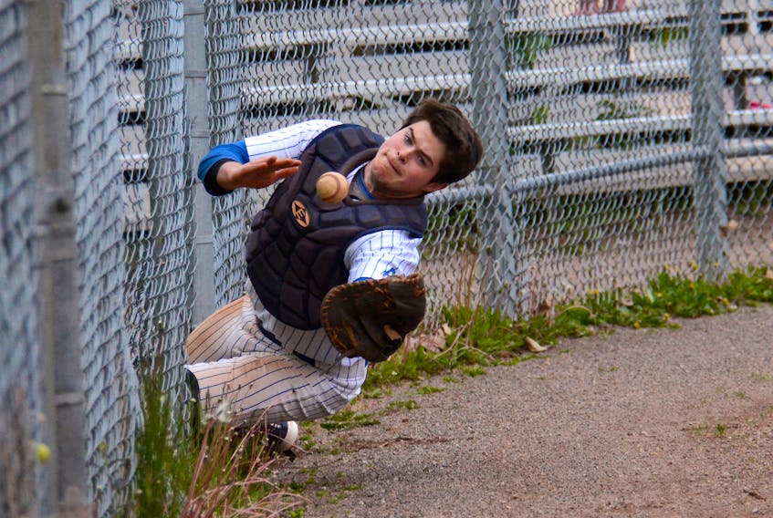 Charlottetown Expos catcher Ben Ladner attempts to catch a foul ball Sunday during Kings County Baseball League action at Memorial Field.