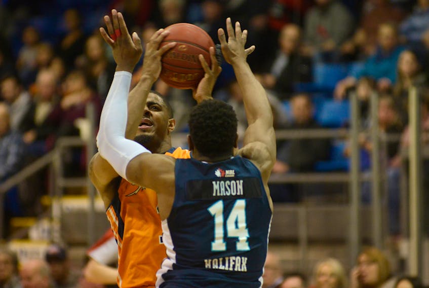 Island Storm guard Chris Johnson takes a shot over Antoine Mason of the Halifac Hurricanes Saturday at the Eastlink Centre in Game 4 of their best-of-five National Basketball League of Canada playoff series.