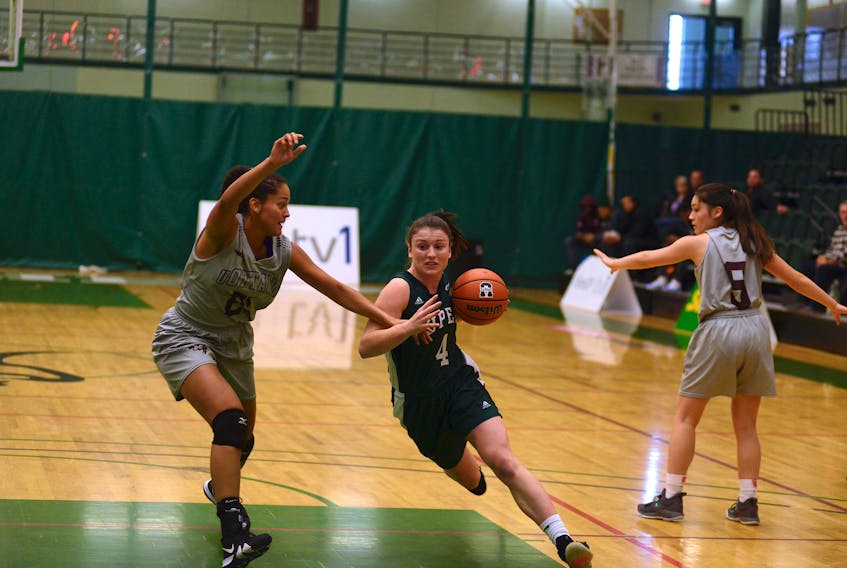 UPEI Panthers guard Jenna Mae Ellsworth, right, gets into the paint on Ottawa Gee-Gees forward Brigitte Lefebvre-Okankwu Saturday during the Mickey Place Memorial Basketball Tournament.