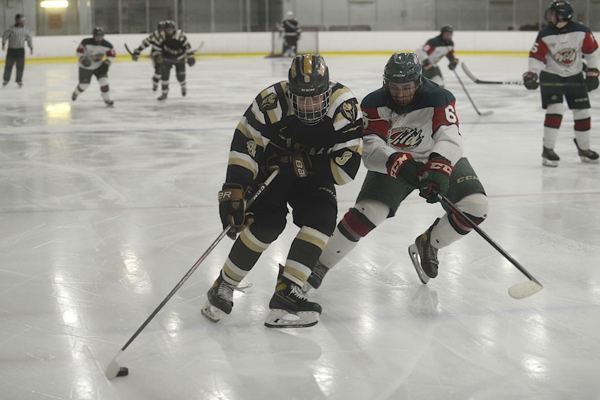 Charlottetown Bulk Carriers Knights forward Jude Campbell, left, tries to drive around Kensington Monaghan Farms Wild defenceman Kieran Rennie during Friday’s Game 3 of the P.E.I. major under-18 hockey championship at MacLauchlan Arena in Charlottetown. - Jason Malloy