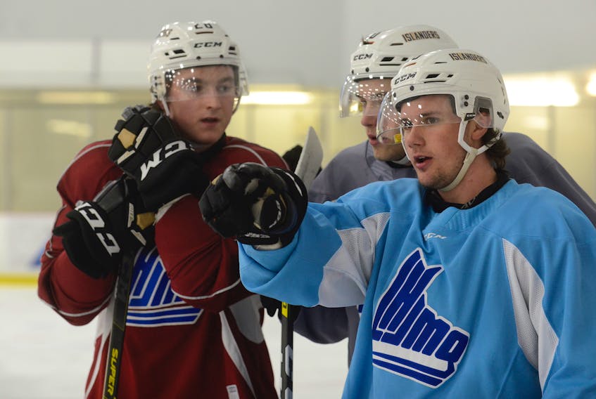 Charlottetown Islanders' centre Zac Beauregard, from right, explains a drill to teammates Brett Budgell and Drew Johnston during a recent practice.
