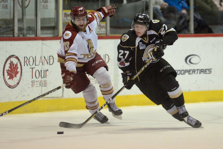 Charlottetown Islanders forward Derek Gentile, right, turns up ice while being defended by Acadie-Bathurst Titan defenceman Adam Holwell Friday at the Eastlink Centre.