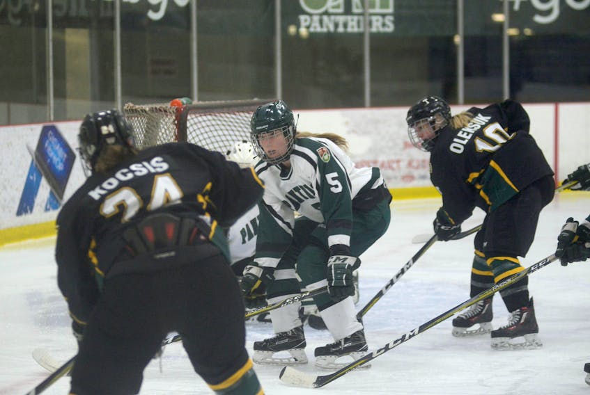 UPEI Panthers defenceman Gabrielle Gray, centre, tries to take a way a passing lane from St. Thomas Tommies  Kristina Kocsis, left, during Friday's Atlantic University Sport women's hockey quarter-final.