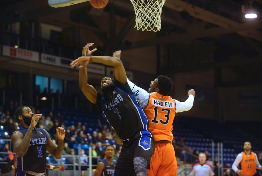 Kitchener-Waterloo Titans forward Nigel Tyghter, left, and Island Storm big man Jailan Haslem battle for the rebound Sunday during National Basketball League of Canada action at the Eastlink Centre.
