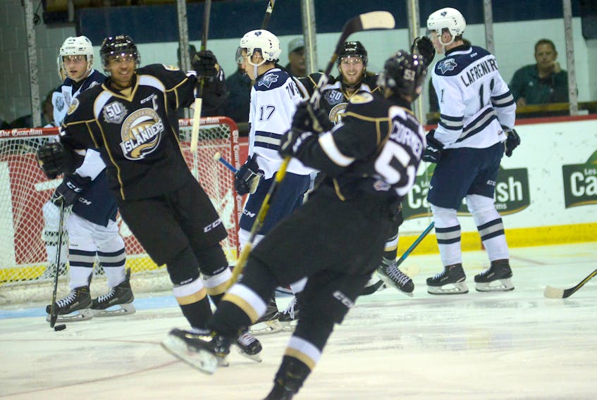 Charlottetown Islanders Pierre-Olivier Joseph and Keith Getson head back to celebrate teammate Lukas Cormier's third-period goal against the Rimouski Oceanic Saturday at the Eastlink Centre.