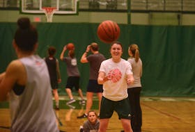 Jenna Mae Ellsworth takes a pass from a teammate at Monday's practice.