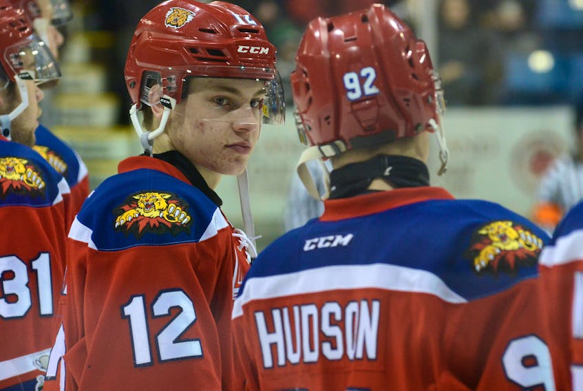 Moncton Wildcats sophomore Jeremy McKenna, centre, talks with teammate Jacob Hudson prior to an pre-game ceremony at the Eastlink Centre on March 17.