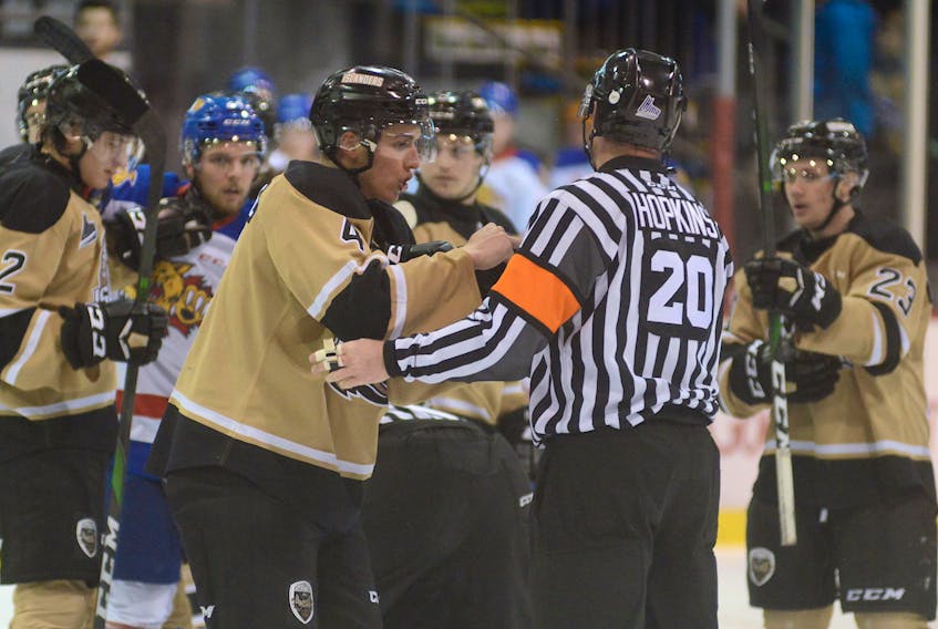 Charlottetown Islanders captain Brendon Clavelle shows referee Jeff Hopkins his finger after being bitten at the end of Sunday's Quebec Major Junior Hockey League game with the Moncton Wildcats.