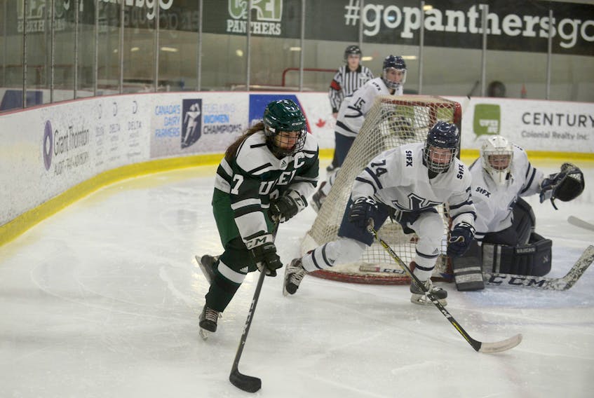 UPEI Panthers captain Emma Weatherbie, left, brings the puck around the St. FX net while being defended by Lea MacLeod Sunday during the final day of the Atlantic University Sport women’s hockey regular season.