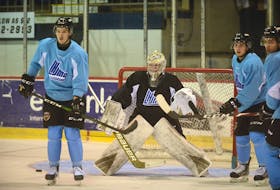Goalie Colten Ellis prepares for a shot from the blue-line Tuesday during the Charlottetown Islanders' first practice of the season at the Eastlink Centre. Looking for a tip or a rebound are, from left, Justin Gill, Cedric Desruisseaux and Patrick LeBlanc.