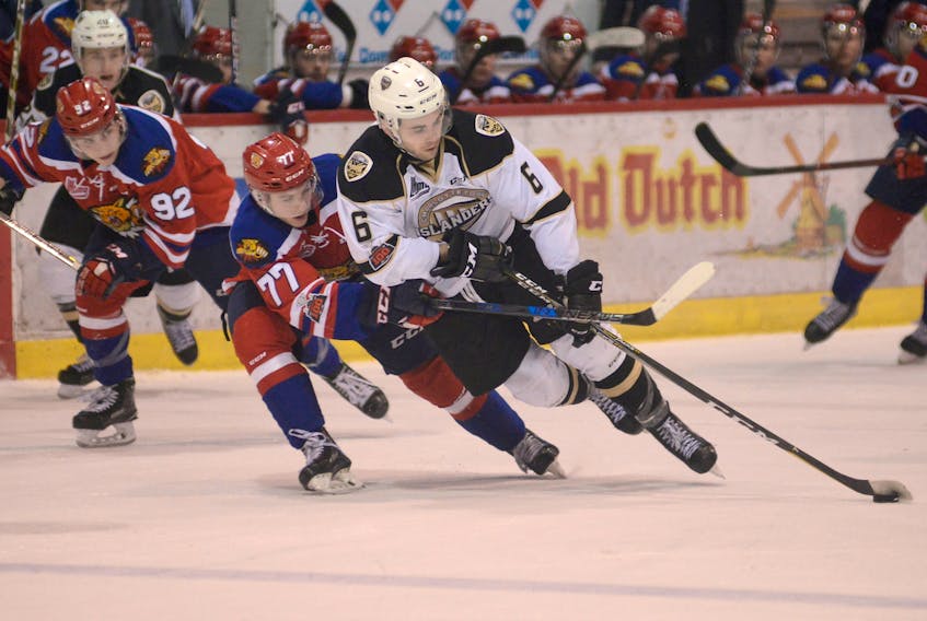 Moncton Wildcats defenceman Nicholas Welsh, left, defends against Charlottetown Islanders left-winger Sam King Saturday at the Eastlink Centre in the final game of the regular season.