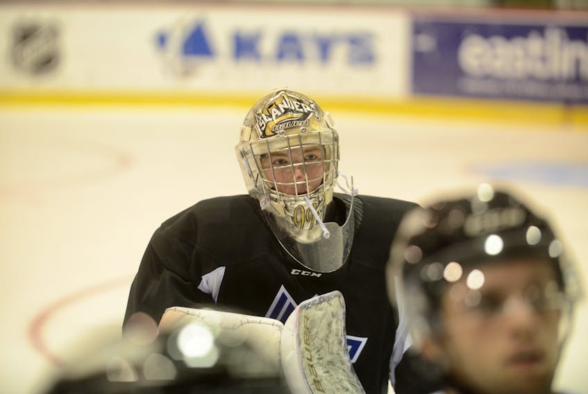 Charlottetown Islanders' goalie Colten Ellis watches as head coach draws up a drill during Tuesday's practice.