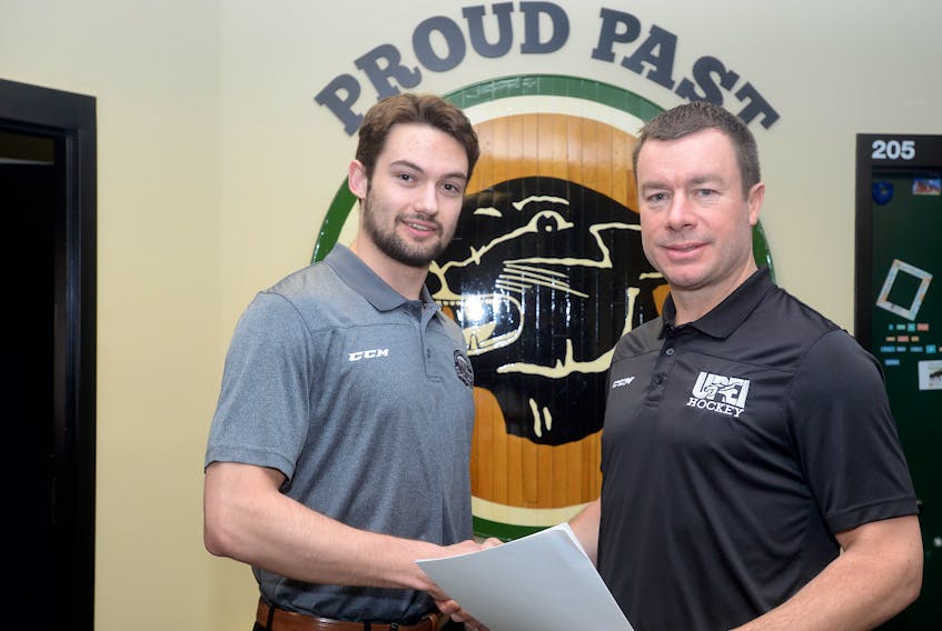 UPEI Panthers men’s hockey coach Forbes MacPherson, right, welcomes Jordan Maher to the team.