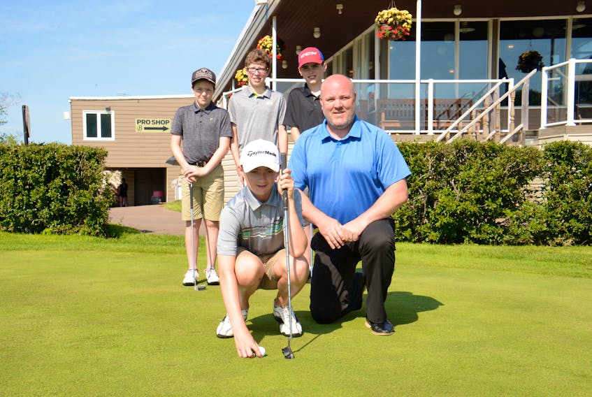 Landon Perry, left, lines up a putt with help from Duane Richards of Kenmac Energy Wednesday at the Belvedere Golf Club in preparation for next week's 31st annual Kenmac Energy Family Golf Classic. Also working on their putting on Wednesday were, standing, from left, Sean Rooney, Aiden Diamond and Easton Fitzpatrick.