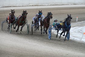 J F Cowboy with Kenny Murphy in the sulky, left, make a charge from the back to win Race 8 Saturday at Red Shores at the Charlottetown Driving Park.