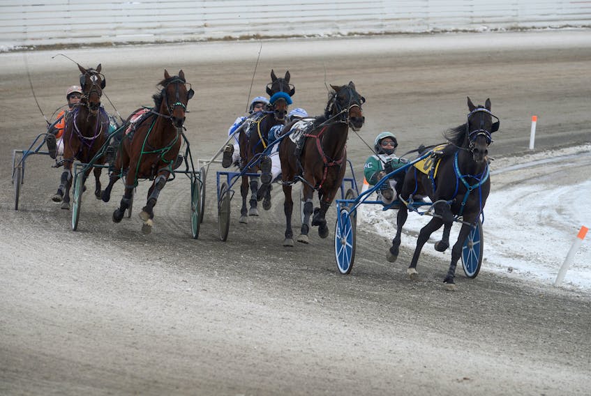 J F Cowboy with Kenny Murphy in the sulky, left, make a charge from the back to win Race 8 Saturday at Red Shores at the Charlottetown Driving Park.