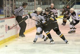 Cape Breton Eagles centre Félix Paré, right, and Charlottetown Islanders defenceman Will Trudeau battle for the puck Saturday during Quebec Major Junior Hockey League action at the Eastlink Centre.