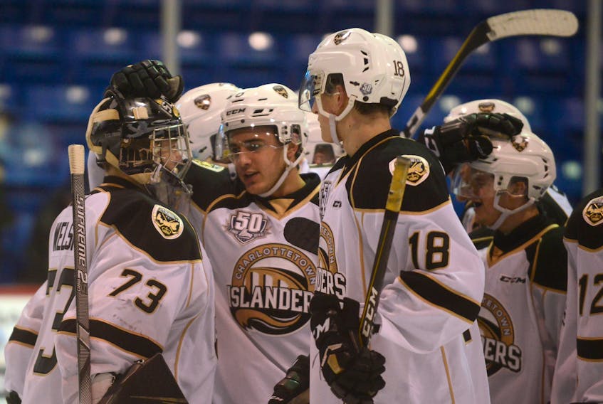 Charlottetown Islanders winger Kevin Gursoy, centre, congratulates goalie Matthew Welsh after Wednesday's game. Both players played leading roles in the victory.
