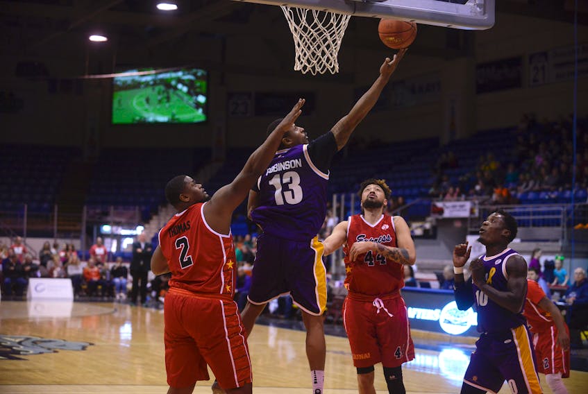 Island Storm guard Robbie Robinson takes a shot over Windsor Express centre Deandre Thomas Sunday during National Basketball League of Canada play at the Eastlink Centre.