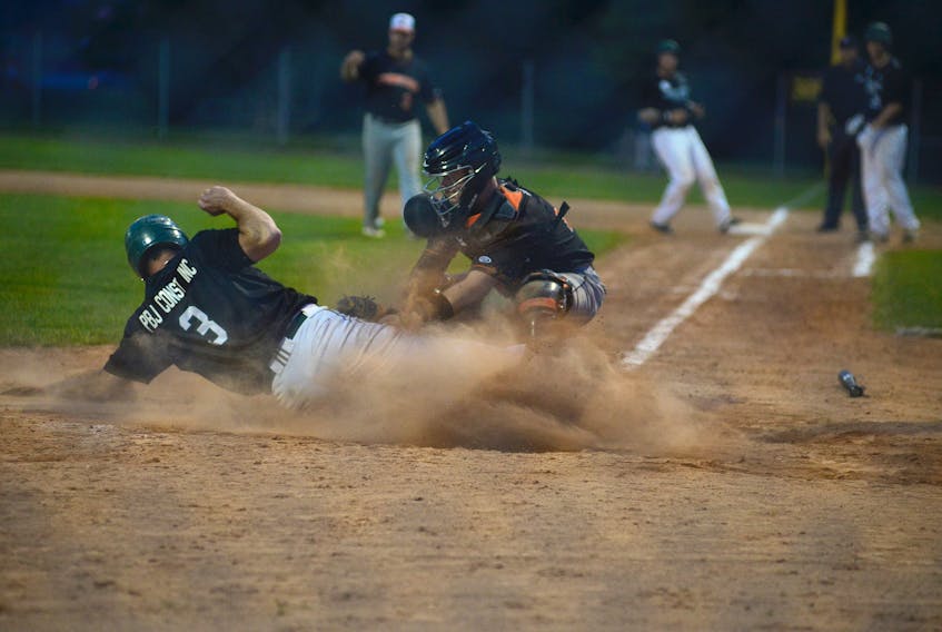 Moncton Fisher Cats catcher Maxime Ruel tags out Dillon Doucette of the Charlottetown Gaudet’s Auto Body Islanders Tuesday during New Brunswick Senior Baseball League action in Charlottetown.