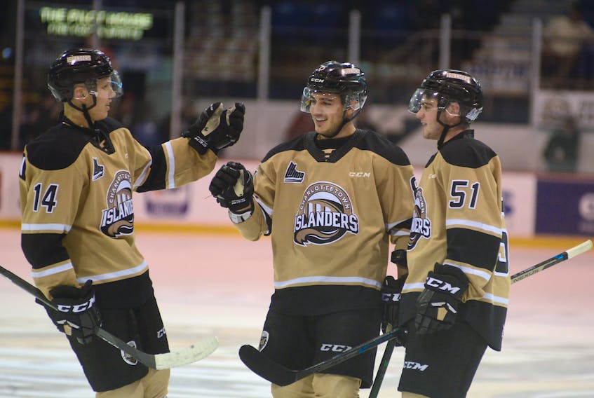 Charlottetown Islanders right-winger Kevin Gursoy, centre, celebrates one of his three goals Friday with teammates Nikita Alexandrov, left, and Lukas Cormier.