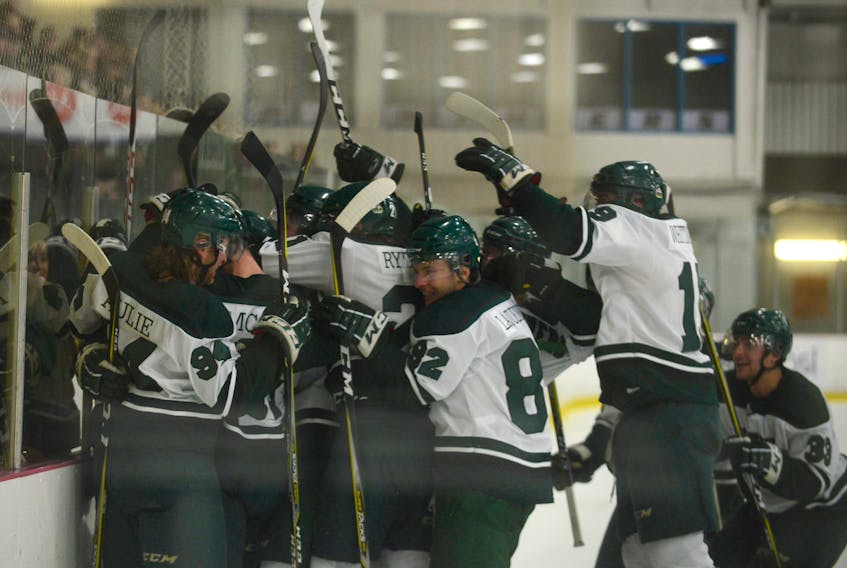 UPEI Panthers celebrate Brent Andrews' overtime winner after Game 1 of the Atlantic University Sport quarter-final with Universite de Moncton Thursday at MacLauchlan Arena.
