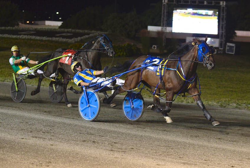 Bugsy Maguire, with Austin Sorrie in the sulky, leads Euchred (Jody Jamieson) to the finish line Saturday night at Red Shores at the Charlottetown Driving Park. Bugsy Maguire won the birthplace of confederation series final in 1:53.2 for owner Walter Simmons of Summerside. Euchred (1:53.4) finished second while Woodmere Ideal Art (1:54) was third.