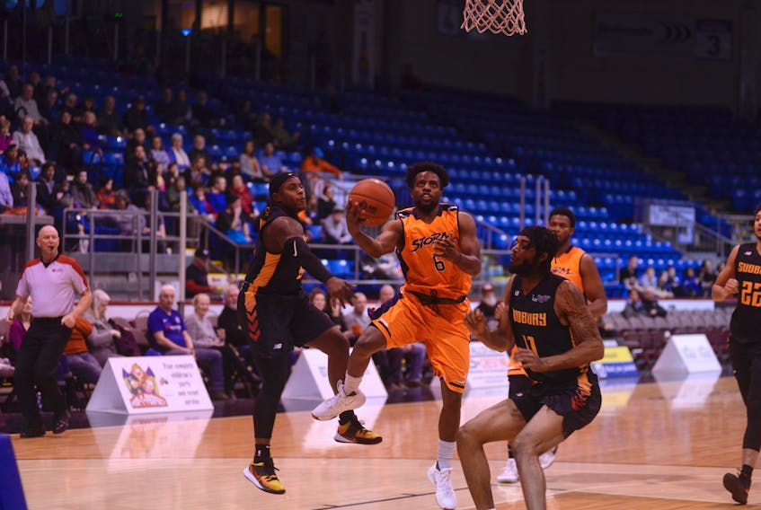 Island Storm point guard Johnathan Loyd, centre, gets into the paint for a layup against the Sudbury Five Friday at the Eastlink Centre.