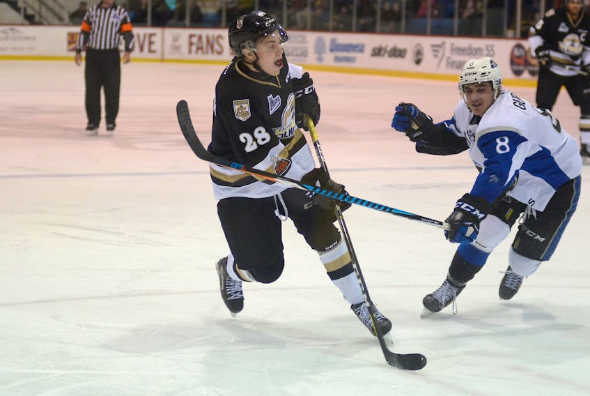 Saint John Sea Dogs forward Kevin Gursoy, right, tries to get to Charlottetown Islanders defenceman Saku Vesterinen before the blue-liner takes a shot during Quebec Major Junior Hockey League play in 2017-18.