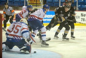 Charlottetown Islanders' centre Justin Gill, right, takes a shot during the second period of Saturday's game with the Moncton Wildcats during Quebec Major Junior Hockey League action at the Eastlink Centre.