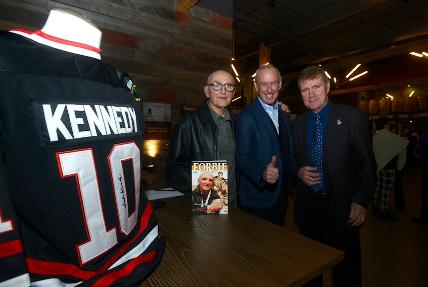 A book launch for “Forbie” was held Wednesday at the P.E.I. Brewing Company. From left are Forbes Kennedy, Ron MacLean of Hockey Night in Canada and Rogers Hometown Hockey and author Gary MacDougall.