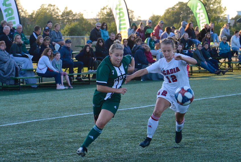UPEI Panthers forward Madison Hurley, left, and Acadia Axewomen defender Meghan Johnston chase a loose ball Friday during Atlantic University Sport women's soccer action in Charlottetown.
