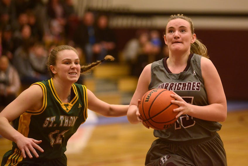 Kassandra Little, right, of the Holland College Hurricanes prepares to take a shot Saturday against the St. Thomas Tommies in Atlantic Collegiate Athletic Association basketball in Charlottetown.