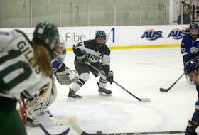 UPEI Panthers fourth-year forward Kaylee Dufresne, middle, looks for the pass from linemate Taylor Gillis during the first period of Thursday's Atlantic University Sport women's hockey quarter-final at MacLauchlan Arena.
