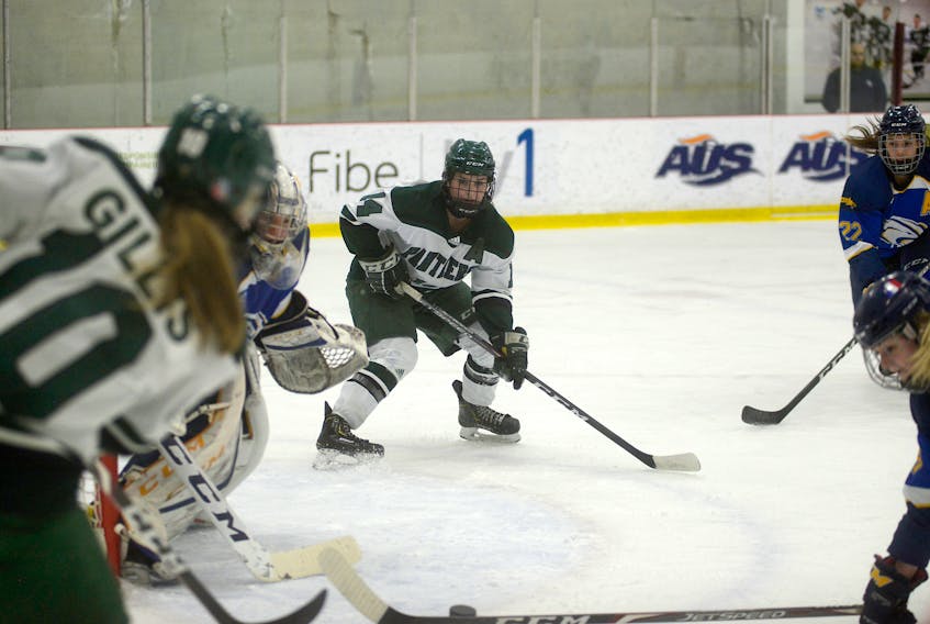 UPEI Panthers fourth-year forward Kaylee Dufresne, middle, looks for the pass from linemate Taylor Gillis during the first period of Thursday's Atlantic University Sport women's hockey quarter-final at MacLauchlan Arena.